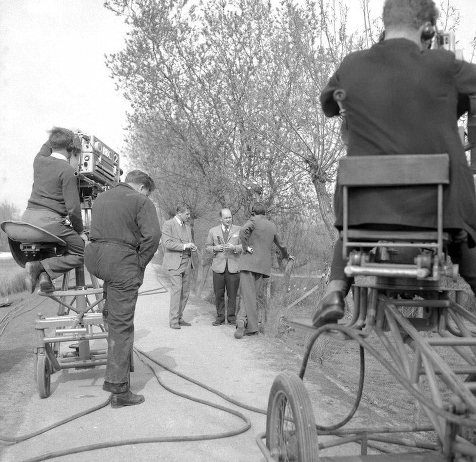 David Attenborough and Peter Scott talking, during a break in filming at Slimbridge, with stage manager Ray Kite.