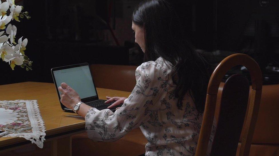 Romanian organised crime expert Silvia Tabusca sitting in front of her computer