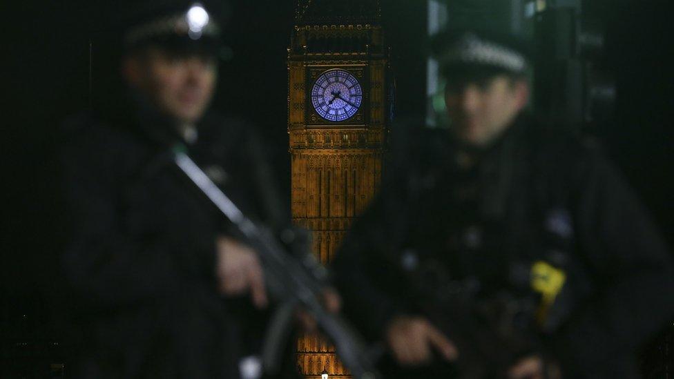 Armed police officer patrol with Elizabeth Tower (Big Ben) in the background ahead