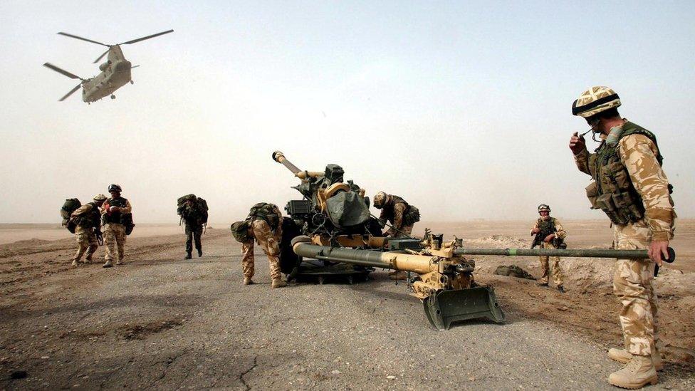 A Chinook helicopter hovers above British soldiers in Iraq in 2003