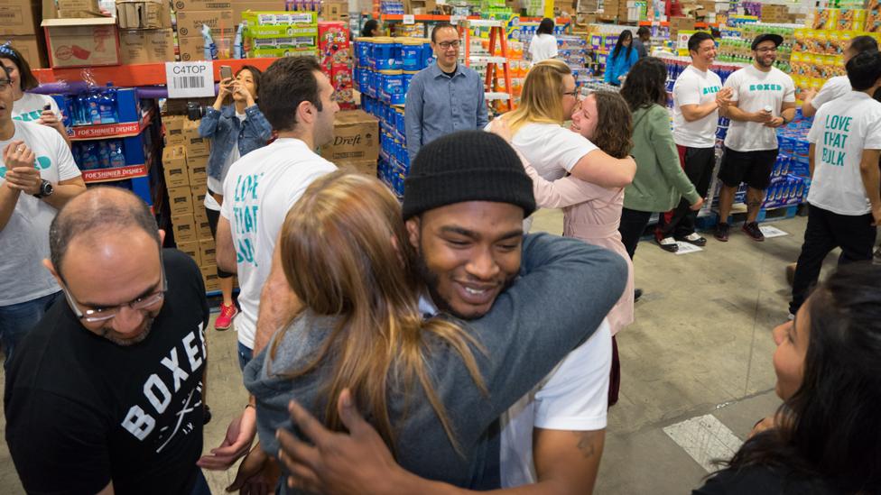Boxed worker Marcel Graham (centre, wearing a hat) celebrates after being told his wedding will be paid for
