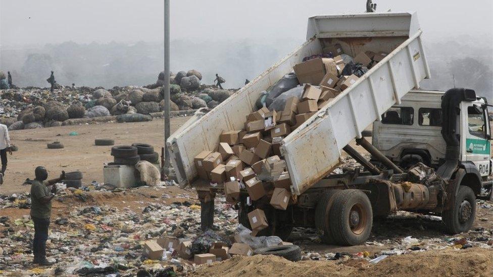 A truck offloads expired AstraZeneca coronavirus disease (COVID-19) vaccines at the Gosa dump site in Abuja, Nigeria, December 22, 2021.