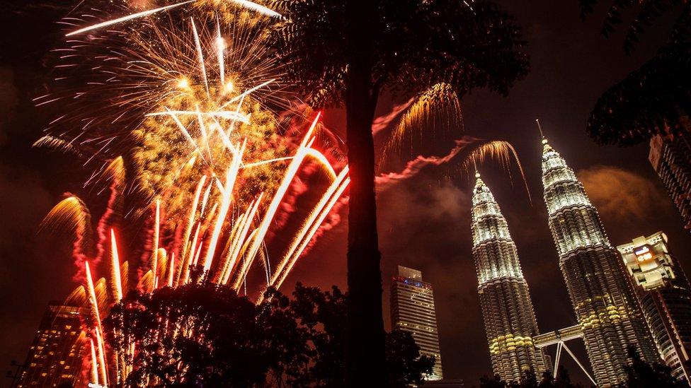Fireworks illuminate the night sky over Malaysia's landmark, Petronas Towers during New Year's Eve celebrations in Kuala Lumpur, Malaysia