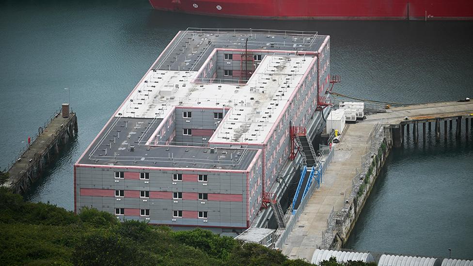 Wide image of the Bibby Stockholm barge docked at port on 12 August