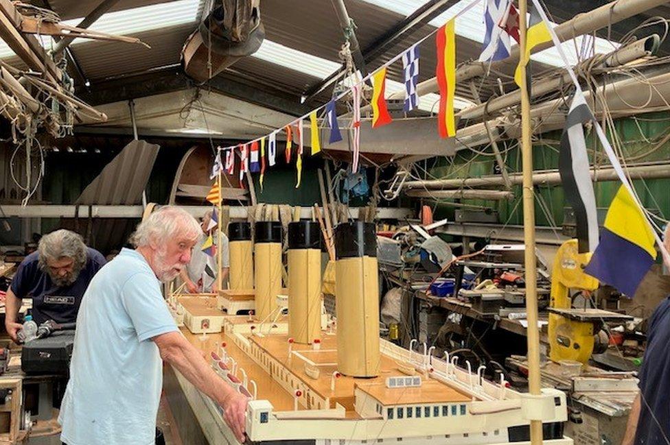 East Belfast Yacht Club members attach bunting to the model of Titanic