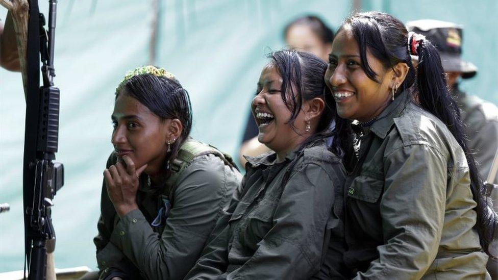 In this Aug. 16, 2016 photo, rebels of the 32nd Front of the Revolutionary Armed Forces of Colombia, or FARC, laugh during a break, at their camp in the southern jungles of Putumayo, Colombia. As Colombia€™s half-century conflict winds down, with the signing of a peace deal perhaps just days away, thousands of FARC rebels are emerging from their hideouts and preparing for a life without arms.