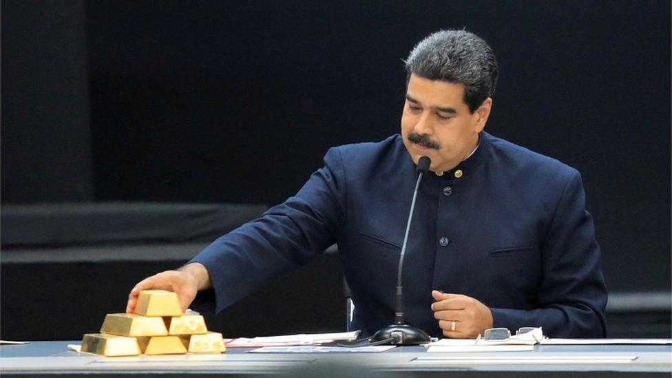 Venezuela"s President Nicolas Maduro touches a gold bar as he speaks during a meeting with the ministers responsible for the economic sector at Miraflores Palace in Caracas, Venezuela March 22, 2018.