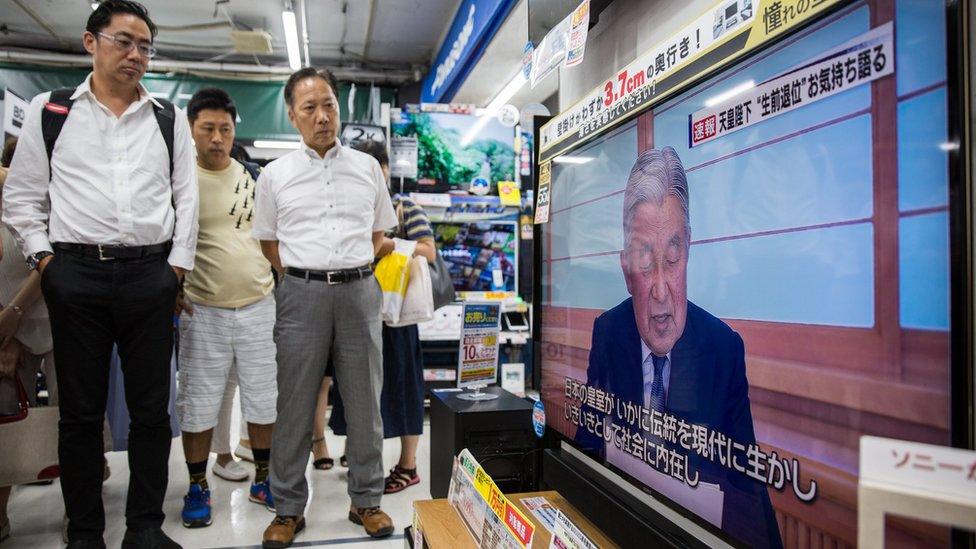 People in a electronics store in Tokyo, Japan, 08 August 2016 watch a TV screen broadcasting Japanese Emperor Akihito, 82, delivering a video message to the public.