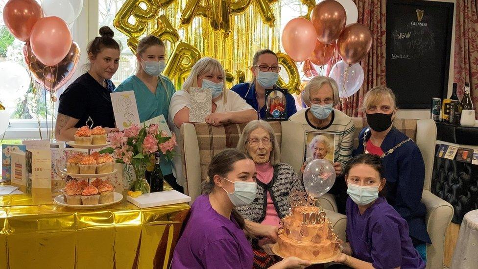 Julia surrounded by carers and family at her birthday celebration
