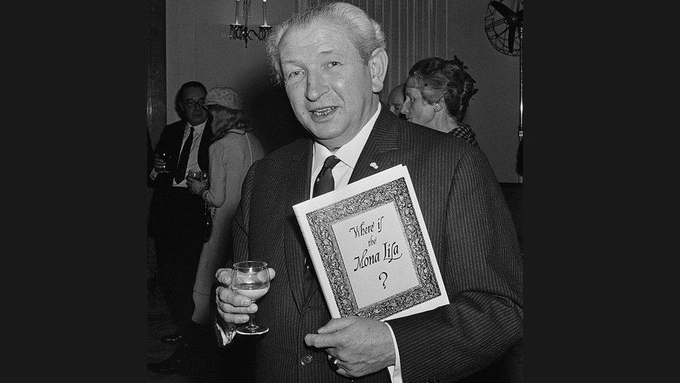 Art collector Henry F. Pulitzer, with a pre-publication copy of his book 'Where Is The Mona Lisa?' at Claridges hotel, London, 1967