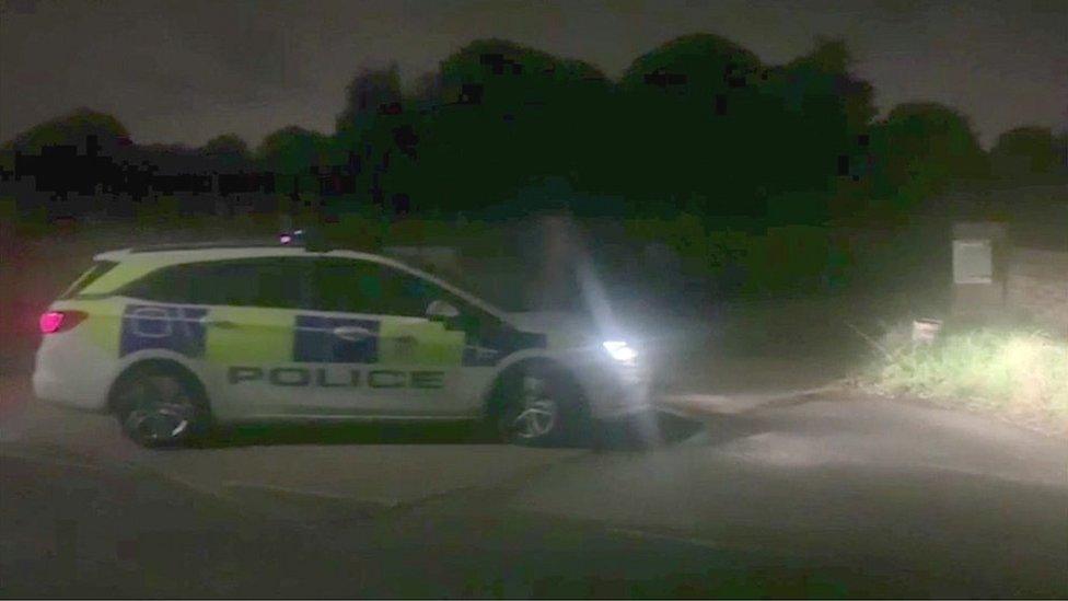 Marked police car outside a property on Park Road, Banstead