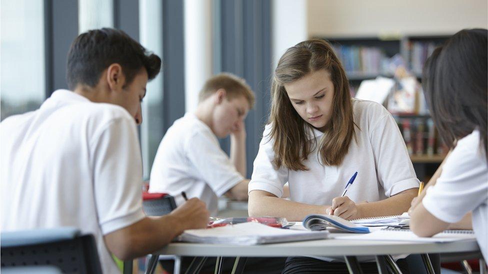 School pupils working around a desk