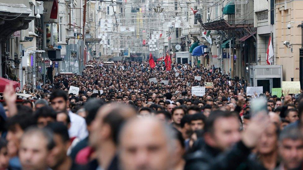 Protestors shout slogans against violence as they gather in reaction to the twin blasts in Ankara, for a rally in Istanbul