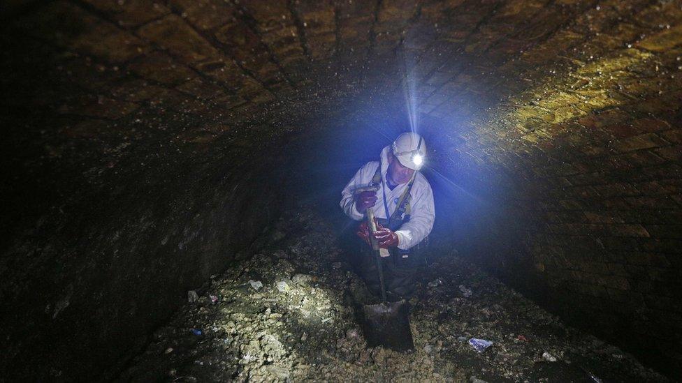 A worker removing fat from a London sewer in 2017