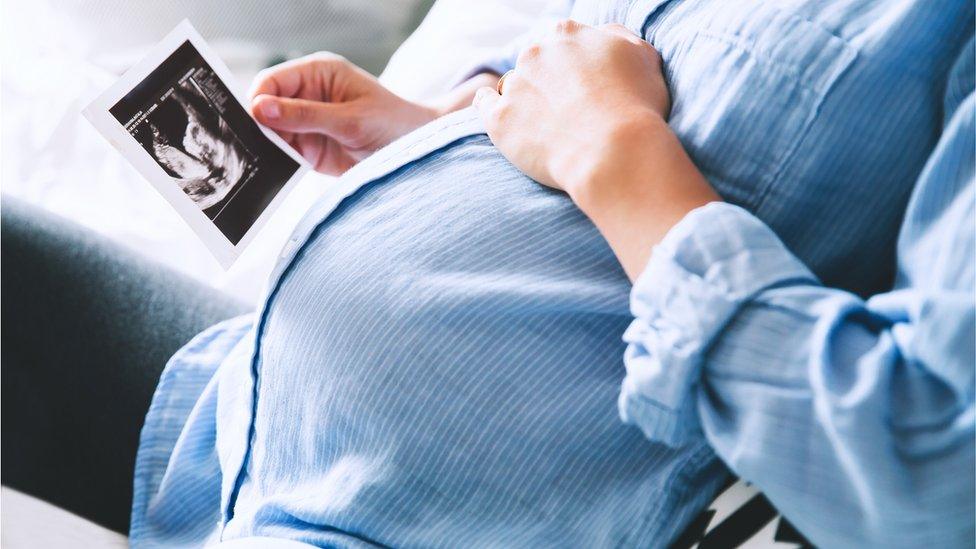 Woman holding a scan picture