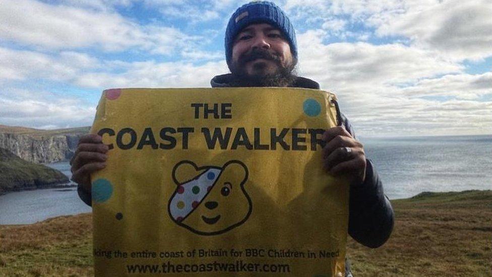 Chris Howard holding a banner promoting BBC Children in Need