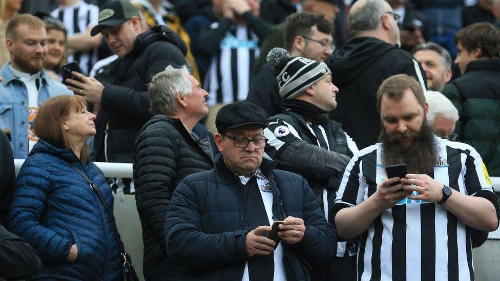 fans-checking-phones-at-football-games.