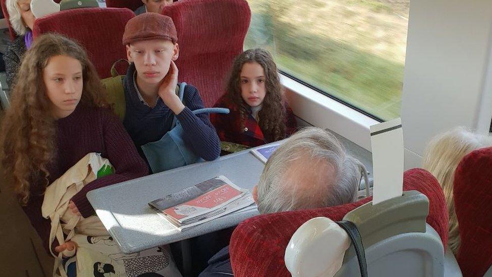 amanda mancino-william's children stare at a couple who refused to leave their reserved seats