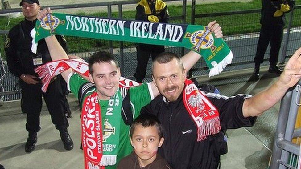 Bangor NISC member Johnny Ferris poses for a snap with one of the bosses from the Polish Hooligan Response Team and his son