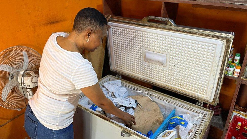 Arinola Omolayo looking in freezer