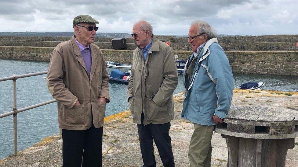 three men by the sea