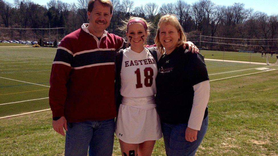 Victoria Graham in her lacrosse uniform at Eastern University, with her parents