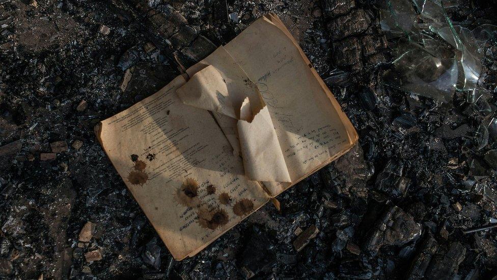 A book in the ashes of a classroom of a school torched in Limpopo, South Africa - May 2016