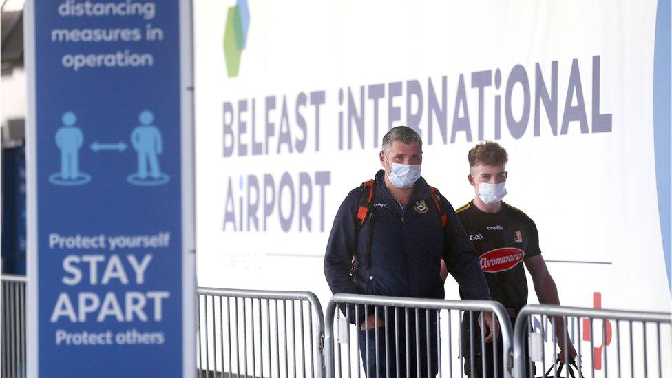 Passengers wearing masks at Belfast International Airport