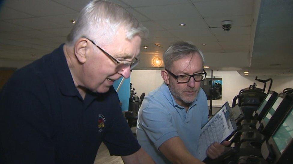 Man on treadmill with gym instructor