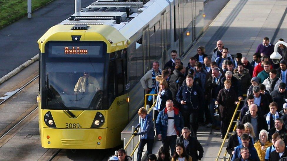 City fans leaving Ashton tram