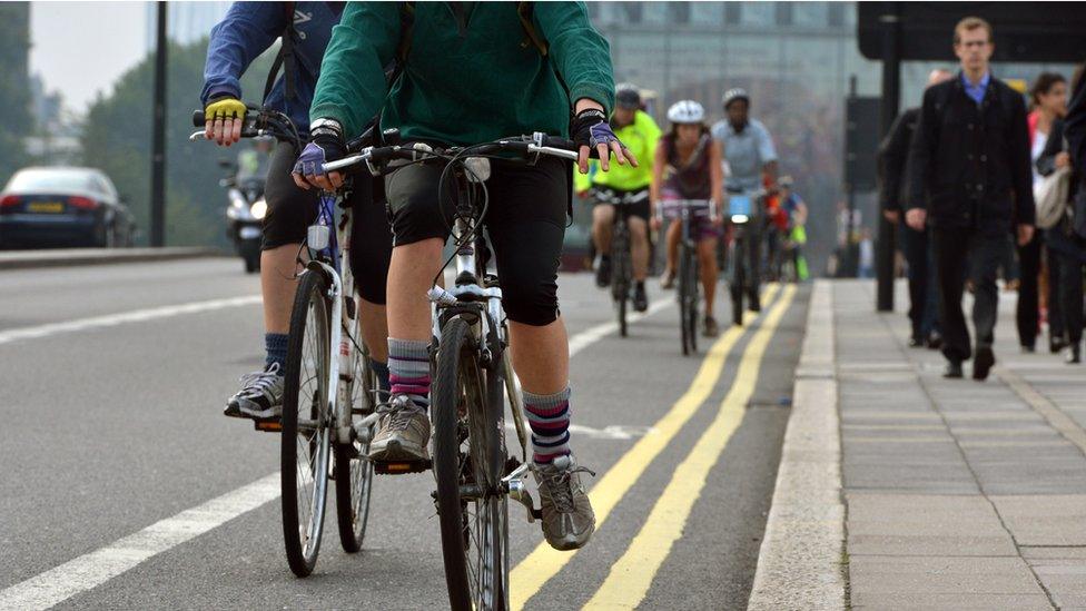 People cycle to work in the morning on Waterloo Bridge, London.