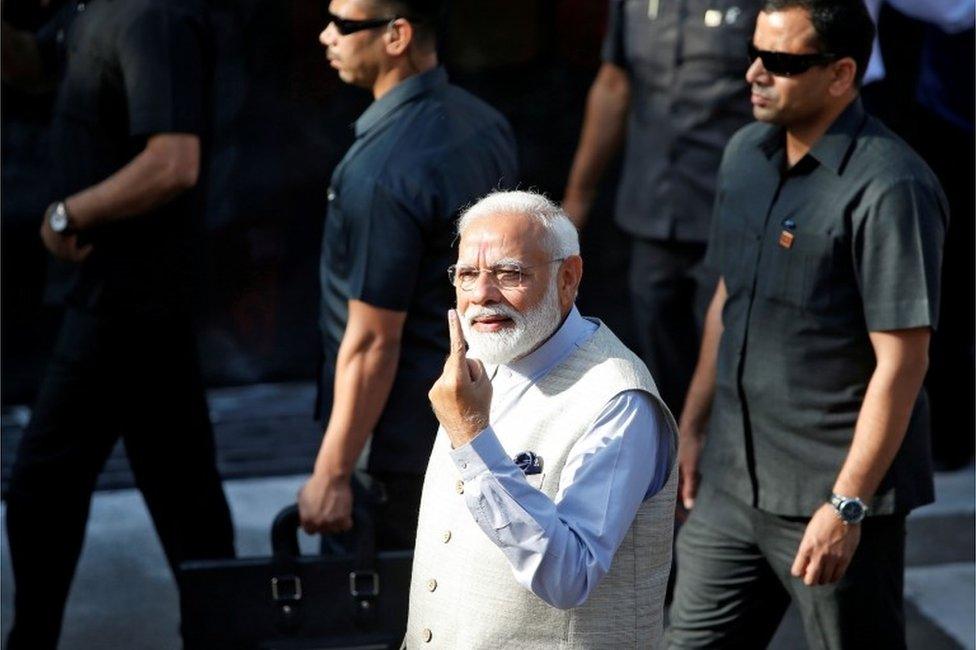 India"s Prime Minister Narendra Modi shows his ink-marked finger after casting his vote outside a polling station during the third phase of general election in Ahmedabad, India, April 23, 2019.