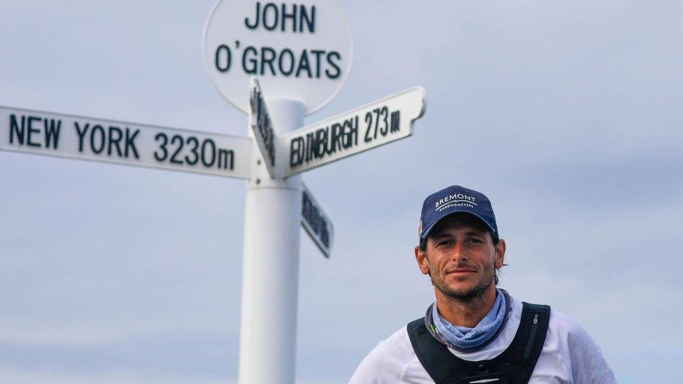 Nick Butter underneath the John O'Groats sign