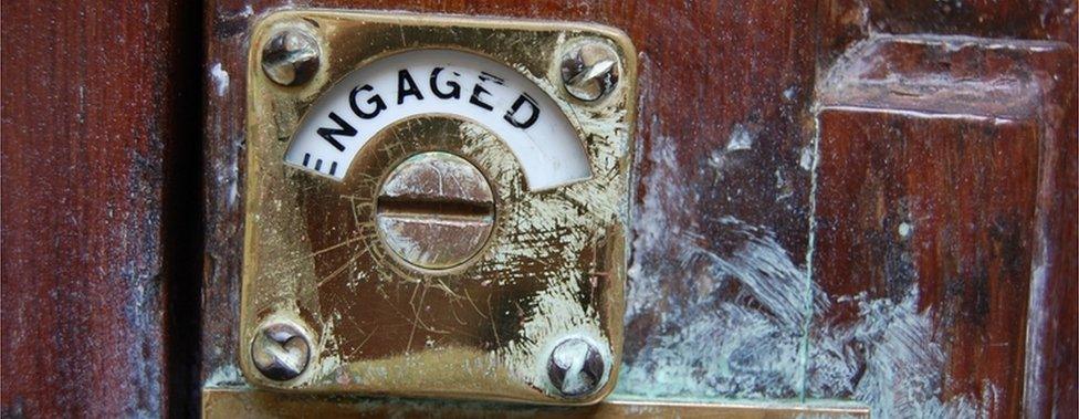 Engaged sign on public toilet door