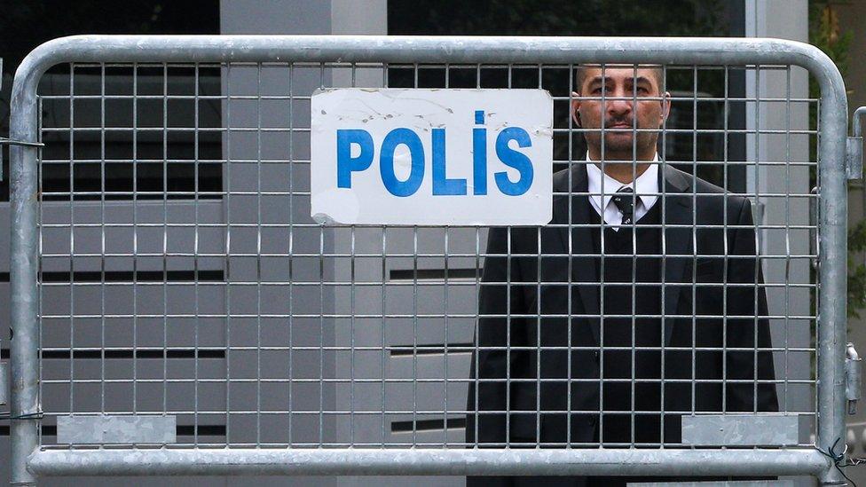 An official stands behind police barriers at the Saudi consulate in Istanbul, Turkey, 21 October 2018