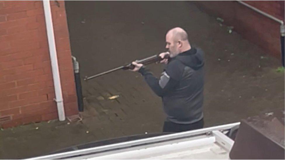 still from footage showing Shaun Wakefield pointing a gun