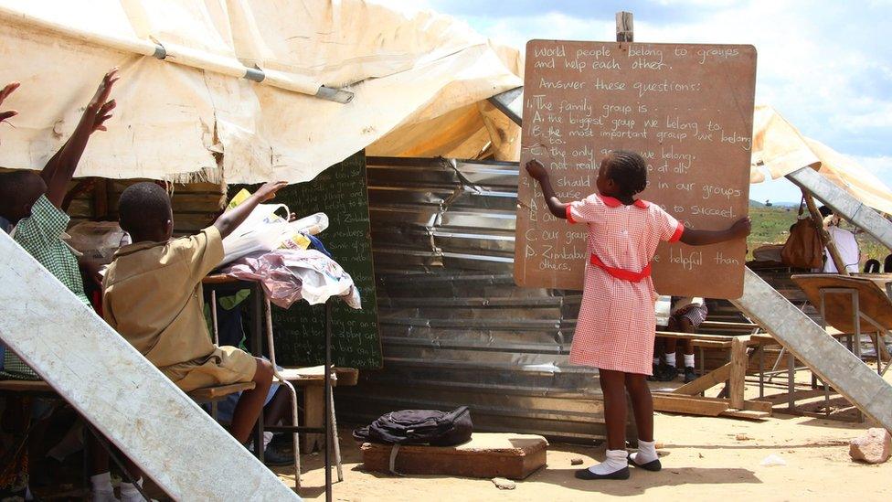 Primary students take lessons under a makeshift classroom because of lack of proper classrooms at the Eastview School in Caledonia, Harare, Zimbabwe, 14 March 2016.