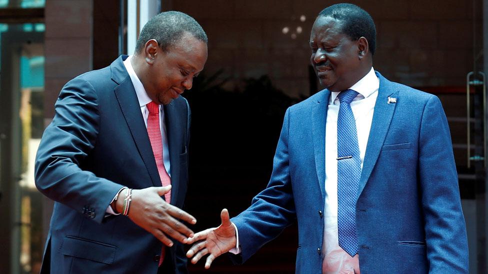 Kenya's President Uhuru Kenyatta (L) greets opposition leader Raila Odinga of the National Super Alliance (NASA) coalition after addressing a news conference at the Harambee house office in Nairobi, Kenya March 9, 2018