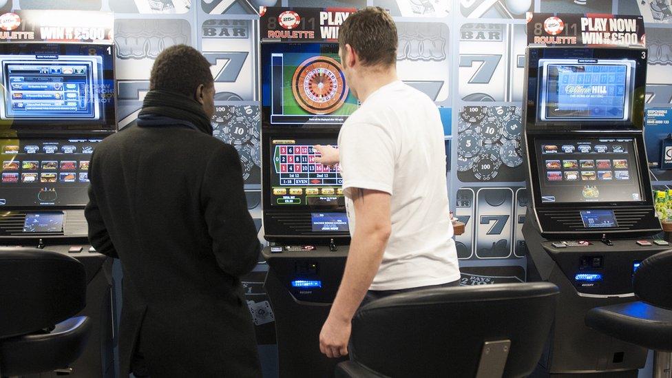 A man tries out a gambling machine