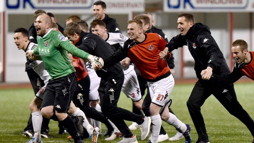 Savouring success - Stephen Baxter and his players link up for a rush towards the delighted Crues support