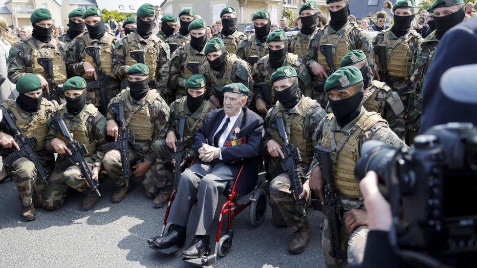 French WWII veteran of the Commando Kieffer, Leon Gautier (C) poses with new members of the Commando Marine Navy special forces after a ceremony in tribute to the 177 French members of the 'Commando Kieffer' Fusiliers Marins commando unit, who participated in the Normandy landings,