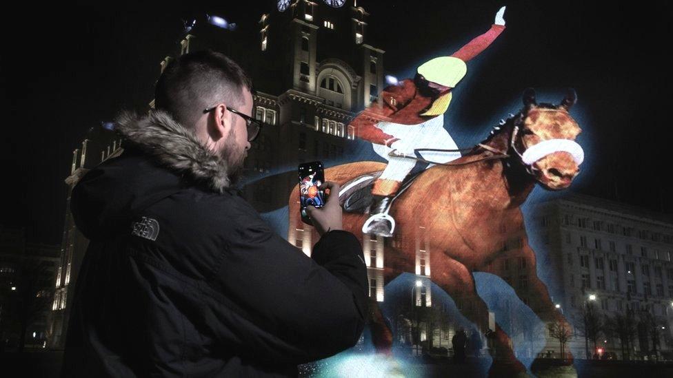 Man takes picture of Red Rum hologram