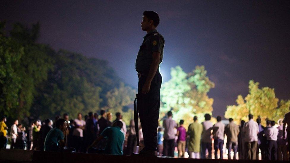 A Bangladeshi policeman stands guard during a peace rally