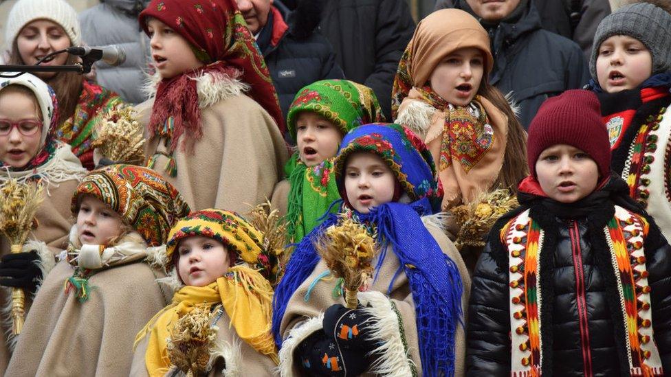 Children in traditional Ukrainian clothes sing carols during the Christmas celebration in Lviv, Ukraine on December 24, 2023