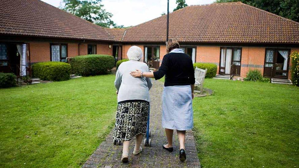 old lady and helper in residential care complex