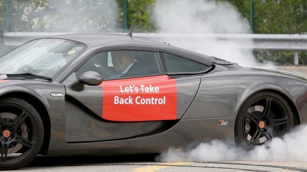 Boris Johnson takes a ride in a sports car