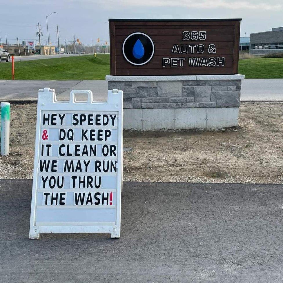 A sign at a pet wash reads 'Hey Speedy & DQ, keep it clean or we may run you through the wash'