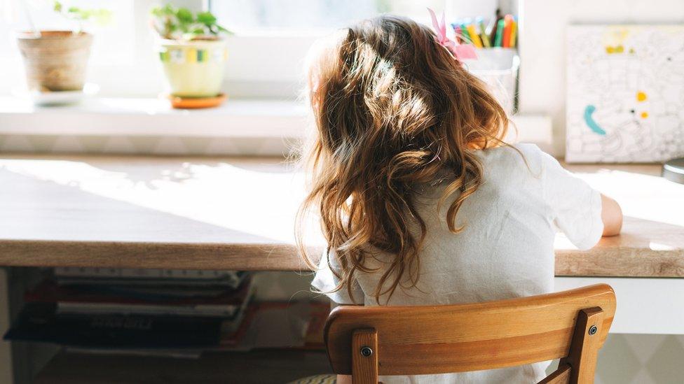 Child working at a desk - generic image