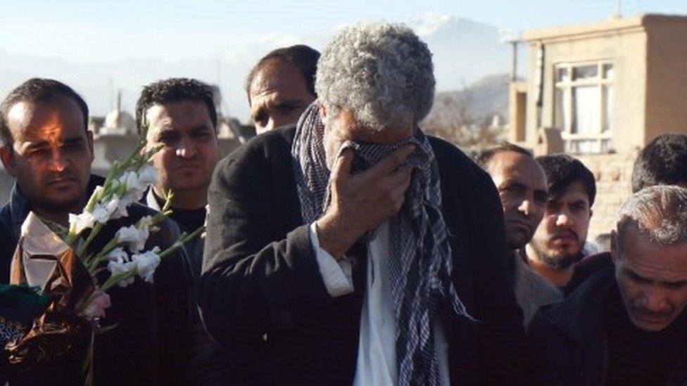 Mourners attend the burial of the victims of a suicide bomb attack in Kabul (21 January 2016)