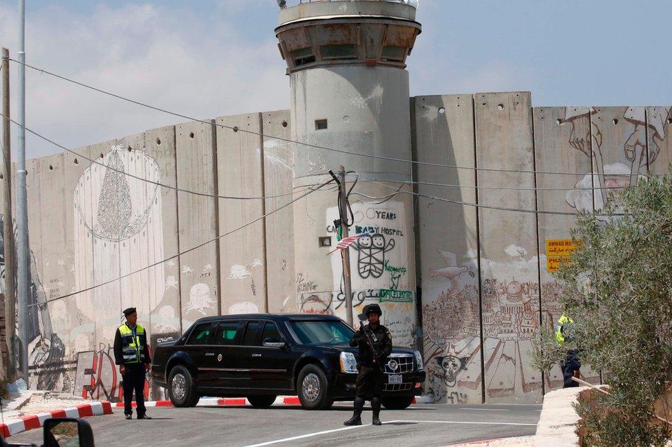 An armoured limousine that is part of the convoy of US President Donald Trump drives past the Israeli West Bank barrier in Bethlehem on 23 May 2017